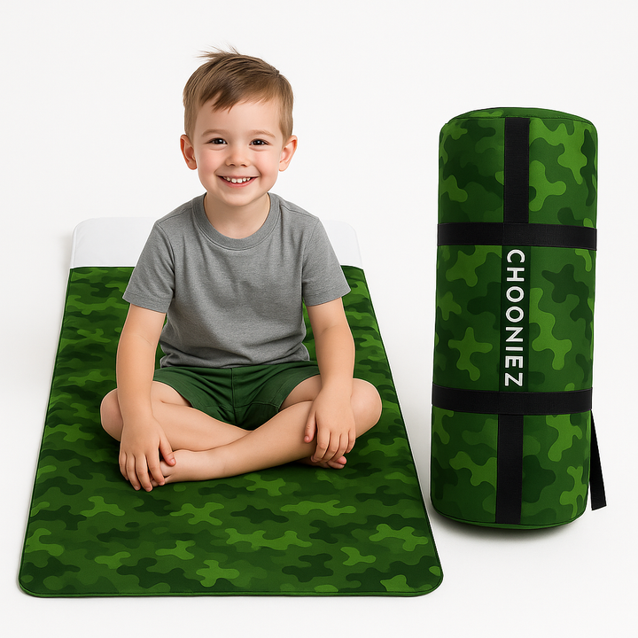 Child sitting on a green camouflage mat with a matching bag labeled 'Chooniez' on a white background